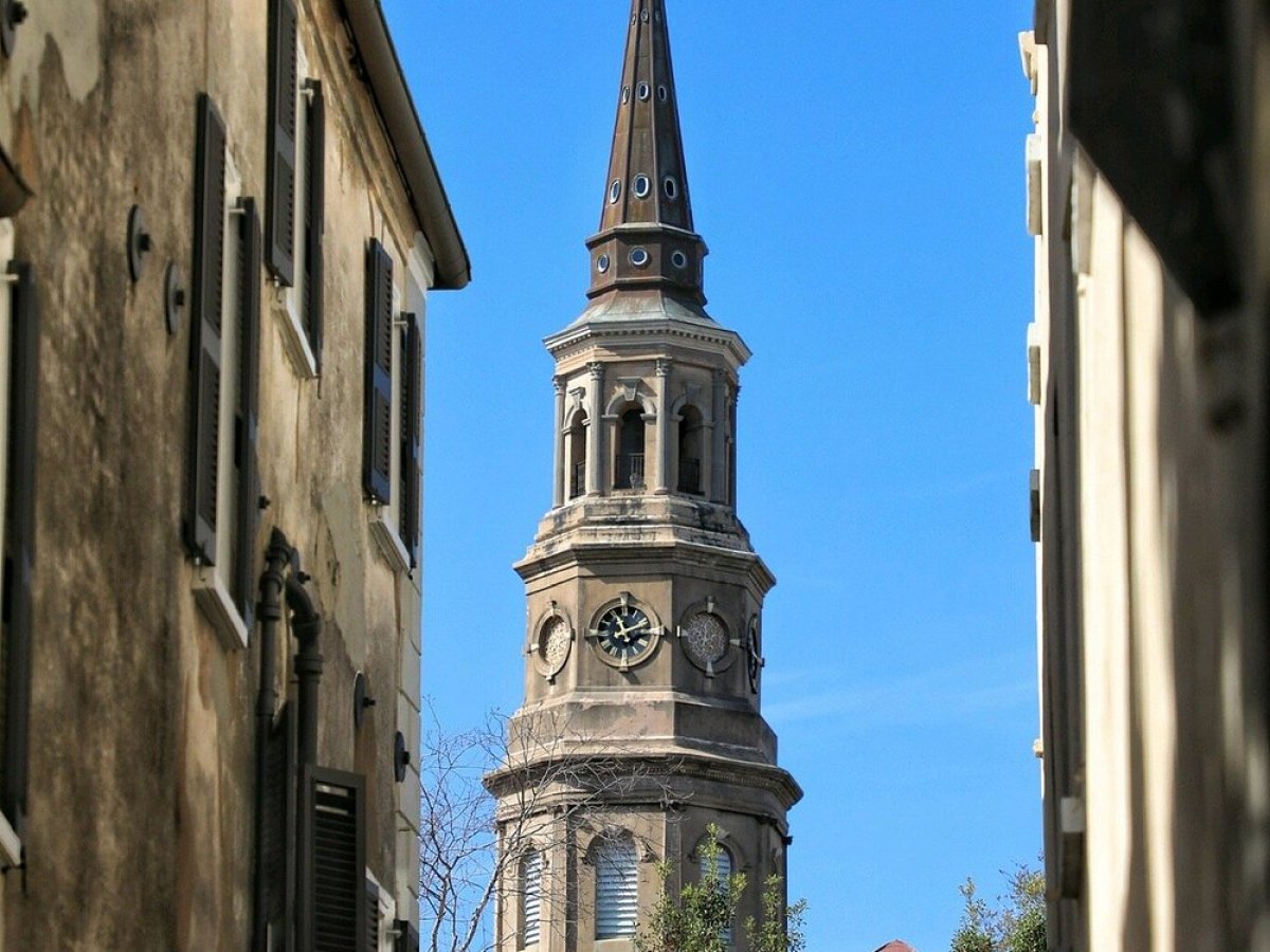 a large tall tower with a clock on the side of a building