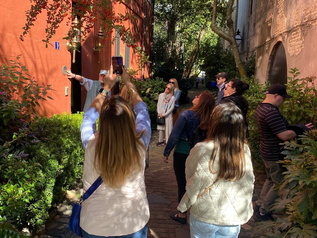 a group of people standing next to a tree