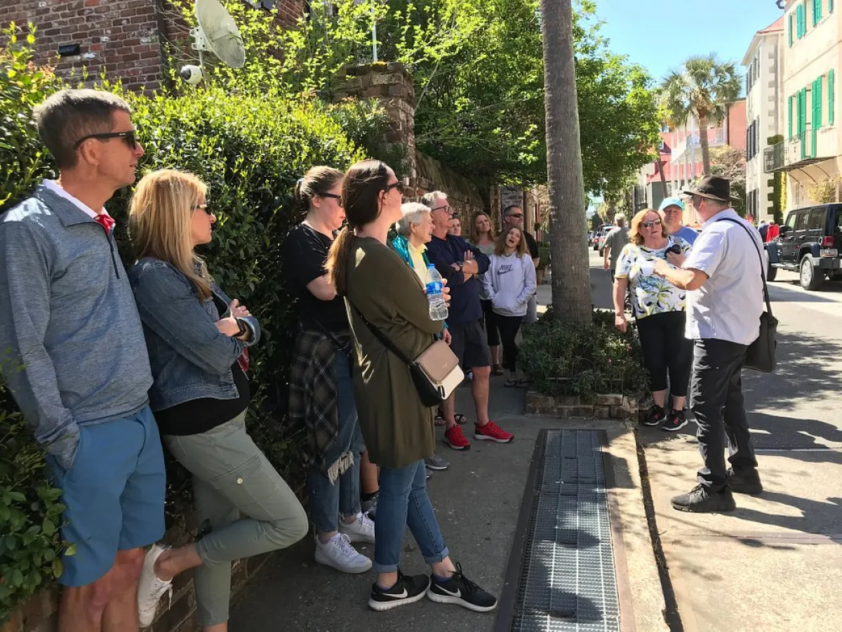 a group of people standing on a sidewalk