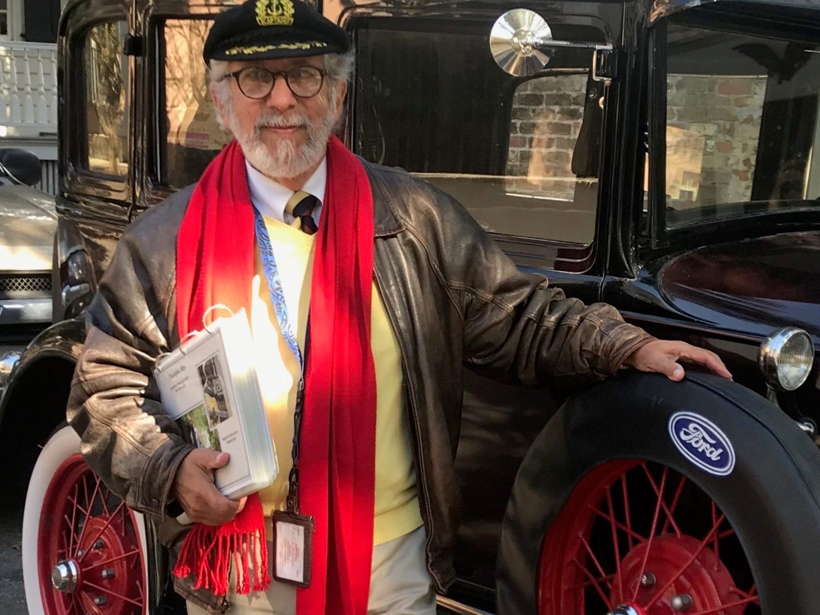 a person standing in front of a red car