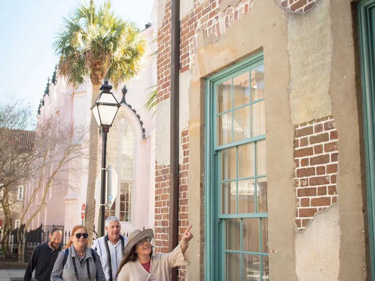 a group of people walking in front of a building