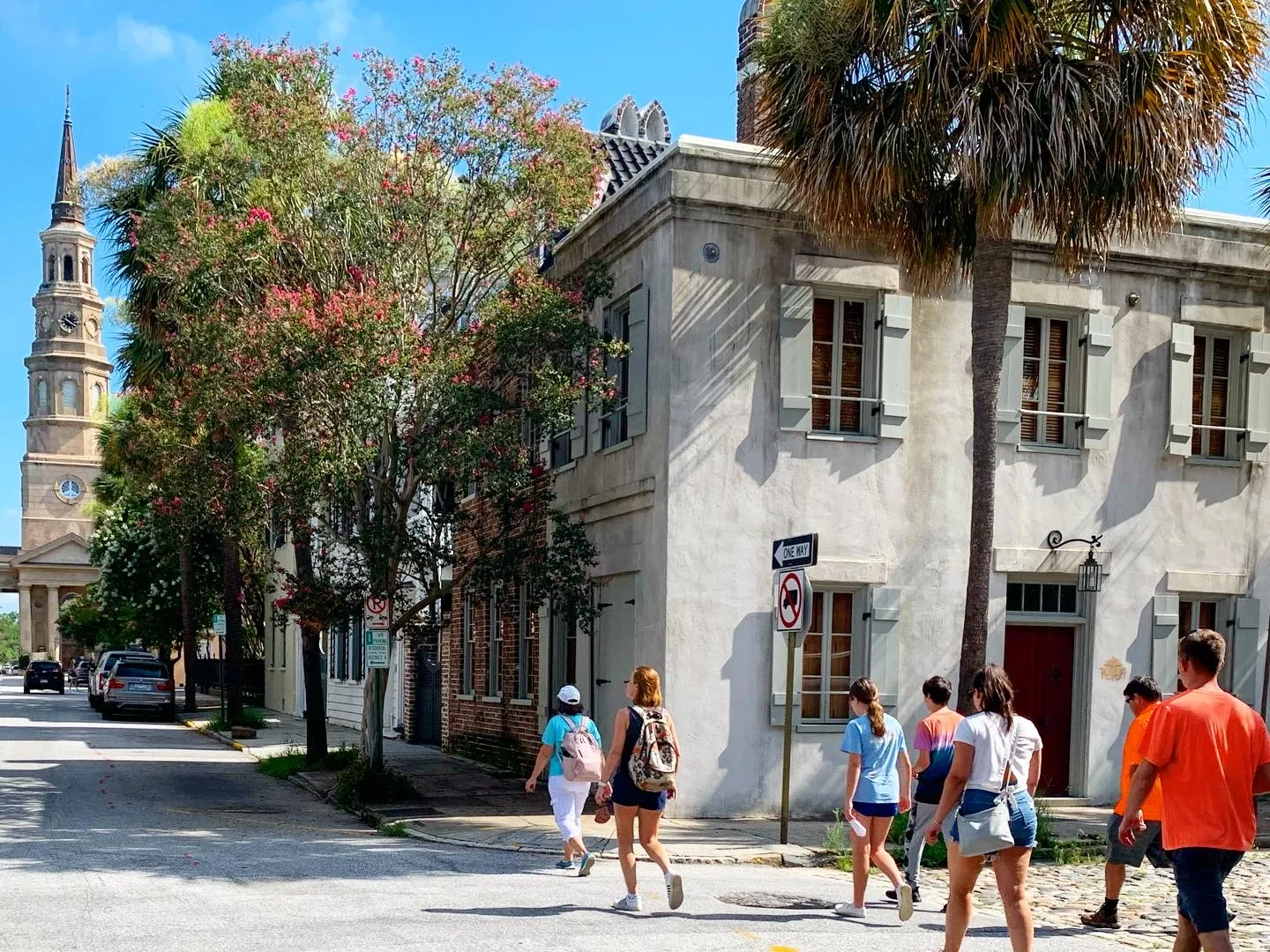 a group of people walking down the street in front of a building