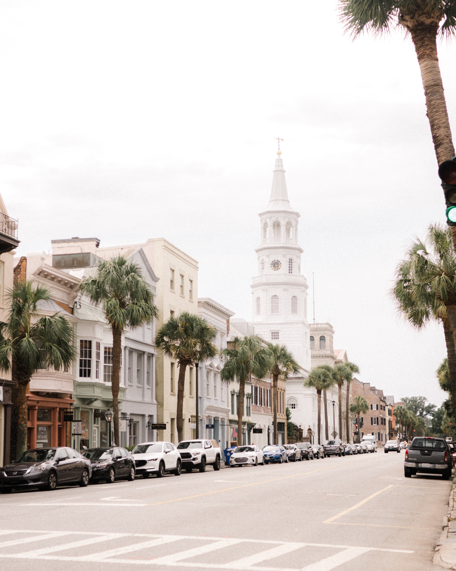 meeting Walks of Charleston a person riding a skateboard down a street next to tall buildings