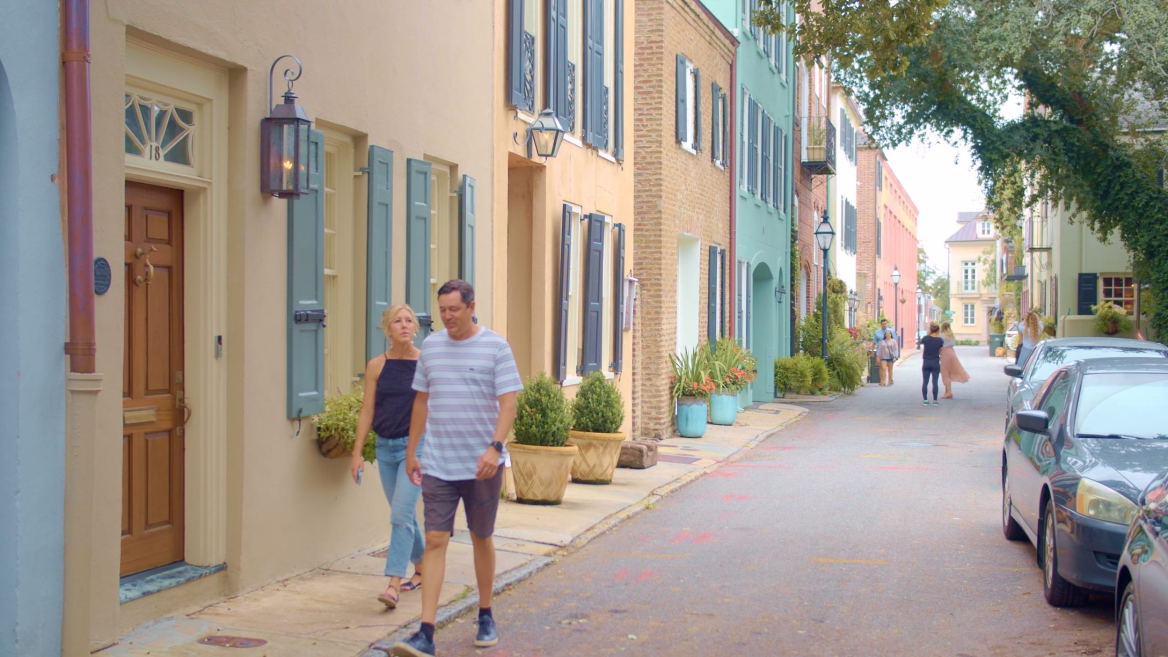 a person walking down a street next to a building
